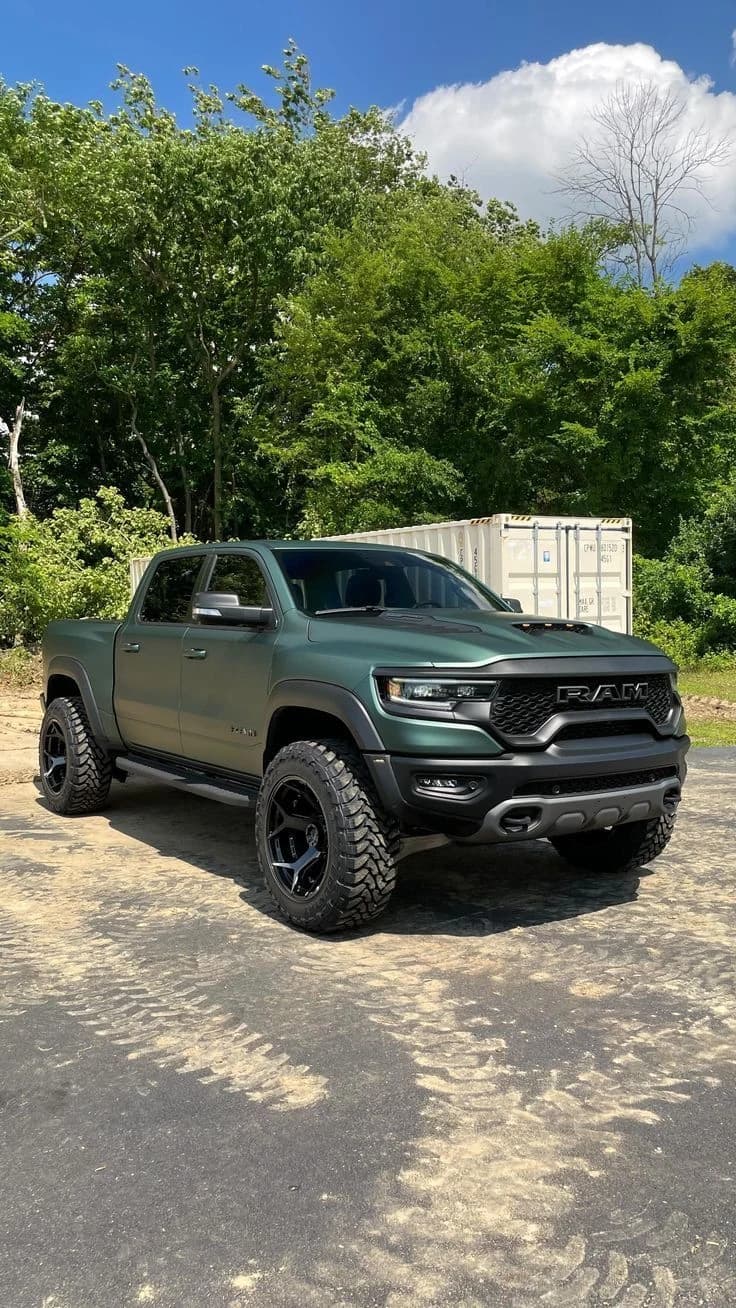 Phone photo of a dark green Ram pickup